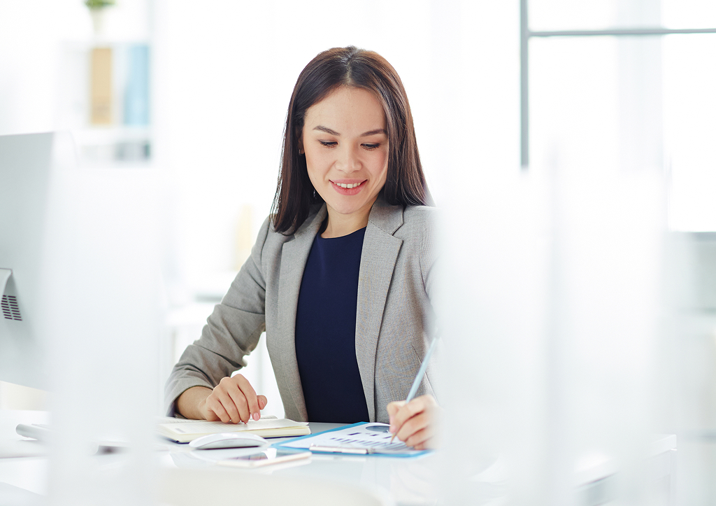Offshore finance professional analysing statistics and data on a screen